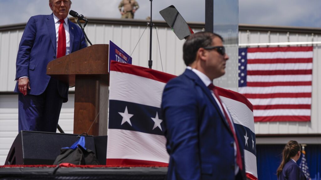 Trump speaks from behind bulletproof glass at first outdoor rally since his attempted assassination