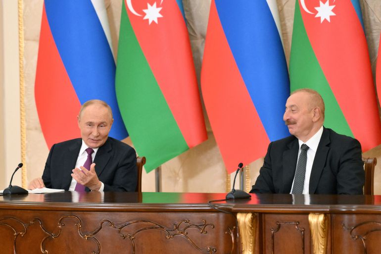 russia's president vladimir putin and azerbaijan's president ilham aliyev attend a joint press conference at the zagulba residence outside baku, azerbaijan august 19, 2024. sputnik/grigory sysoev/kremlin via reuters attention editors - this image was provided by a third party.