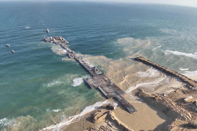 ships are seen near a temporary floating pier built to receive humanitarian aid in the gaza strip in gaza beach, in this handout picture obtained by reuters on may 18, 2024. israel defense forces/handout via reuters this image has been supplied by a third party