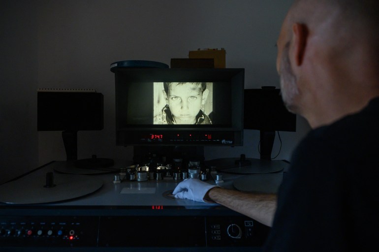 archivist matthieu larroque inspects a reel of film showing scenes of daily life in palestine, part of a collection of 40 palestinian films made between 1960 and 1980, at the conservation and research center of the toulouse cinematheque in toulouse, southwestern france, on august 1, 2024.