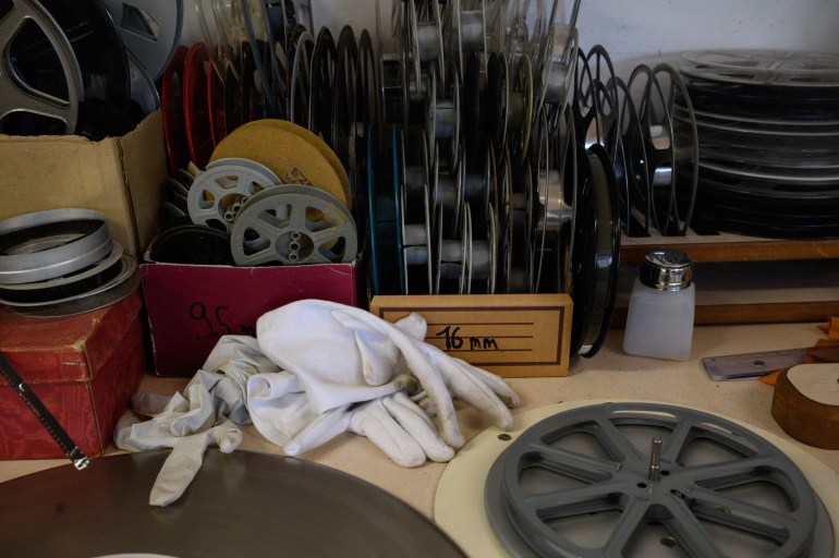 this photograph shows film equipment stacked on a desk at the conservation and research center of the toulouse cinematheque, in toulouse, southwestern france, on august 1, 2024.