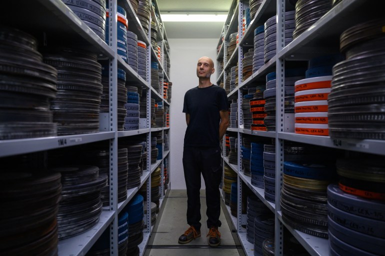 archivist matthieu larroque poses during a photo session at the conservation and research center of the toulouse cinematheque, in toulouse, southwestern france, on august 1, 2024.