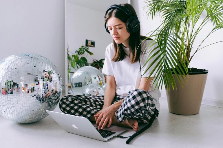 woman in white crew neck t-shirt using macbook