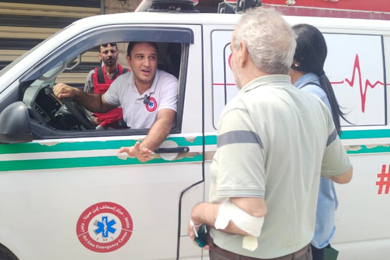 صورة 1_ 28-8-2024- فاطمة محمود جنين فلسطين الجزيرة نت_ المريض ماهر فزاع بعد خروجه من المستشفى الحكومي عقب التهديد باقتحامه يتحدث مع ضابط الاسعاف لنقله لاكمال علاجه