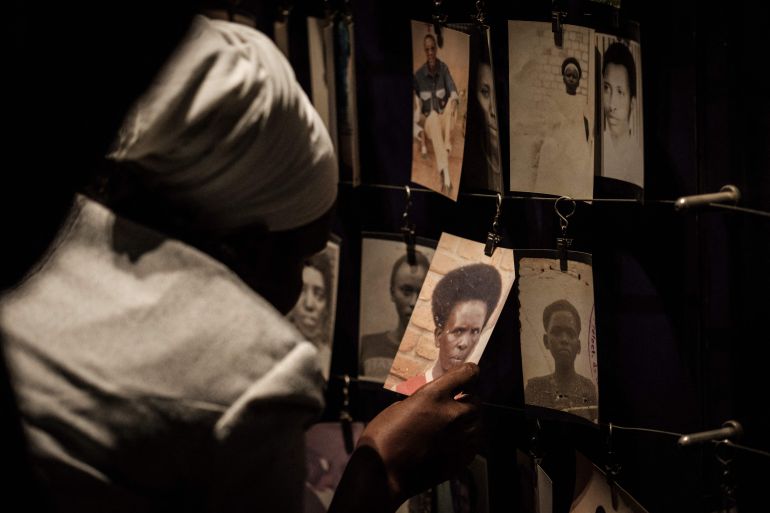 (files) a picture taken on april 29, 2018 shows a visitor looking at victims' portraits at the kigali genocide memorial in kigali, rwanda. rwanda will on april 7, 2024 commemorate the 30th anniversary of the genocide during which hutu extremists targeting the tutsi minority slaughtered around 800,000 people in a massacre lasting 100 days. (photo by yasuyoshi chiba / afp)