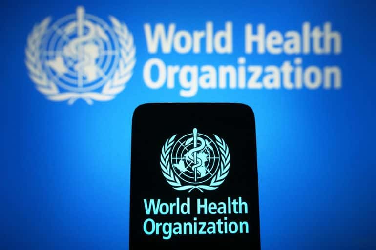 UKRAINE - 2024/01/31: In this photo illustration, the World Health Organization (WHO) logo is seen on a smartphone and in the background. (Photo Illustration by Pavlo Gonchar/SOPA Images/LightRocket via Getty Images)