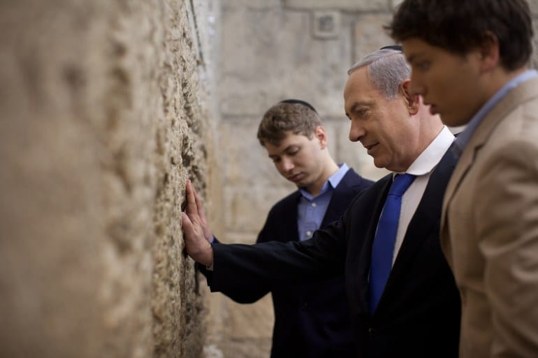 JERUSALEM, ISRAEL - JANUARY 22: Israeli Prime Minister Benjamin Netanyahu prays with his sons Yair and Avner at the Western Wall, Judaism holiest site on January 22, 2013 in Jerusalem, Israel. Israel's general election voting has begun today as polls show Netanyahu is expected to return to office with a narrow majority. (Photo by Uriel Sinai/Getty Images)