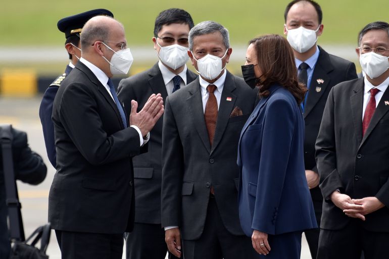 u.s. vice president kamala harris is greeted by singapore foreign minister vivian balakrishnan and his delegation, as she arrived at paya lebar air base in singapore