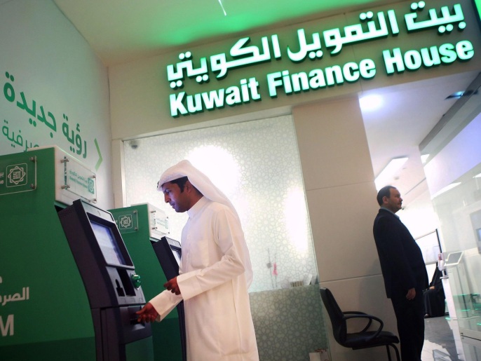 to go with afp eco story by omar hasana kuwaiti man withdraws cash from an atm outside a kuwait finance house branch inside the avenues mall, the largest shopping centre in kuwait on november 19, 2014. the international monetary fund (imf), the world bank, and other global economic bodies estimate that the assets of islamic financial institutions grew nine-fold to usd 1.8 trillion between 2003 and last year. afp photo/ yasser al-zayyat