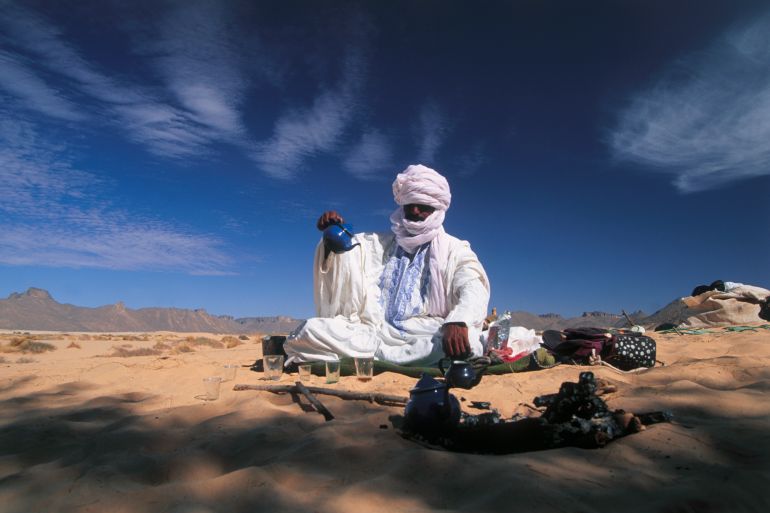 Nomad Making Tea in Desert