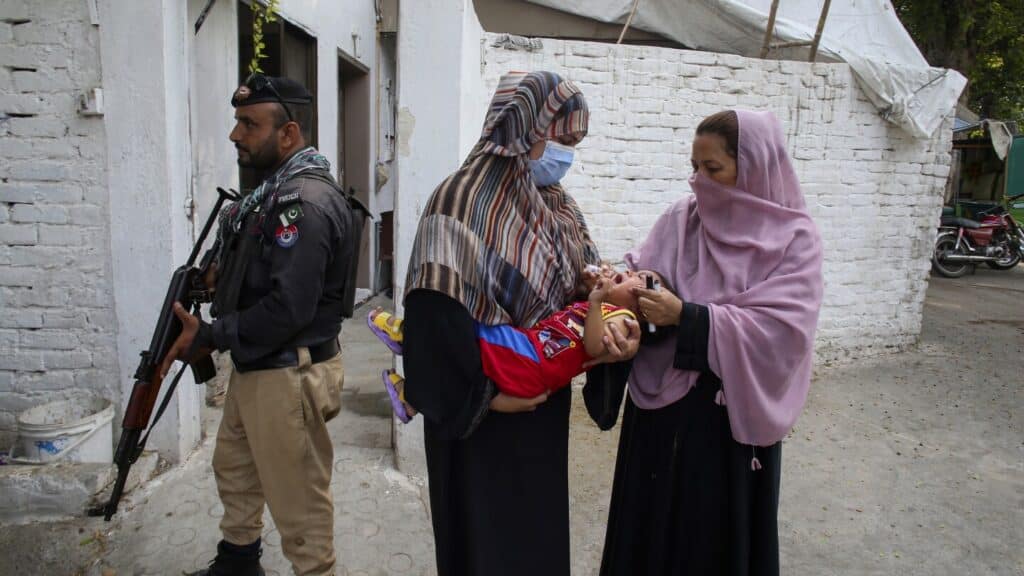 A bomb hits a vehicle guarding an anti-polio drive in Pakistan and wounds 9