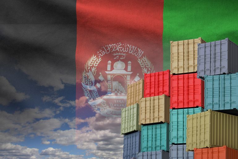 Afghanistan flag and big stack of shipping cargo containers in docks with sky background close up