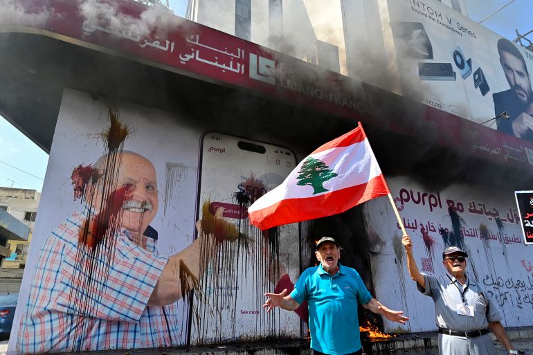 epa11570808 a protester shouts slogans during a protest organized by depositors' outcry, a group campaigning for the rights of depositors, in the dora area, northern beirut, lebanon, 29 august 2024. bank customers demand they be allowed to withdraw their savings, which have been blocked as a result of the ongoing economic crisis in the country, as the lebanese pound has lost about 95 percent of its value against the us dollar. the currency was trading on the parallel market at 89,500 against the dollar on 29 august, more than five times the 15,000 official rate. epa-efe/wael hamzeh