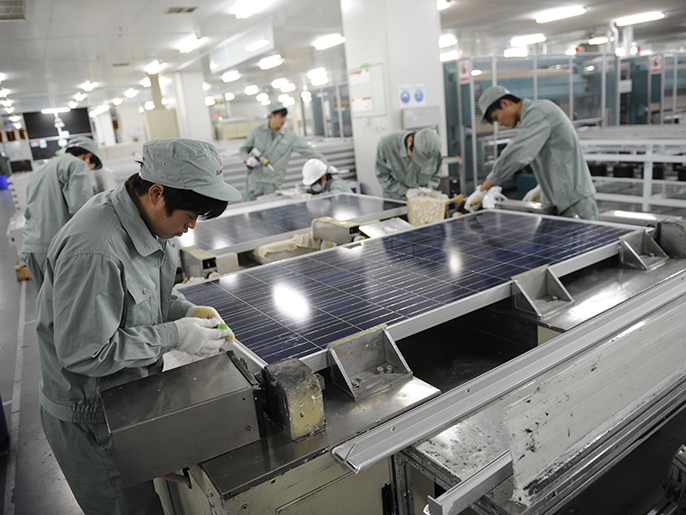 to go with china-us-solar-company-distress-suntech,focus by bill savadove this picture taken on february 27, 2012 shows workers assembling solar panels on the factory floor of chinese company suntech in the eastern chinese city of wuxi. china's suntech has made a painful journey from being the world's largest solar panel producer to flirting with bankruptcy in just a year, highlighting the woes of the industry it shaped. afp photo / peter parks