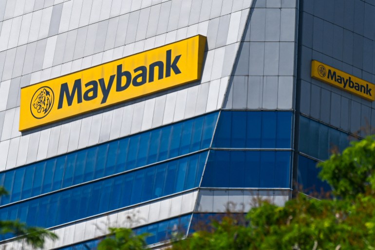 the company signage of maybank is seen on a building facade at raffles place financial business district in singapore on march 18, 2024. (photo by roslan rahman / afp)