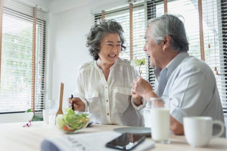 happy senior adult couple eating healthy salad together. lovely grandmother feeding to her grandfather. lover, retirement, wellness. beh3althy; shutterstock id 2150038033; purchase_order: aljazeera ; job: ; client: ; other: