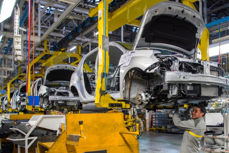 a factory employee works on a car assembly line at the renault-nissan tanger car assembly plant in melloussa, east of the port city of tangiers on march 12, 2018. (photo by fadel senna / afp)