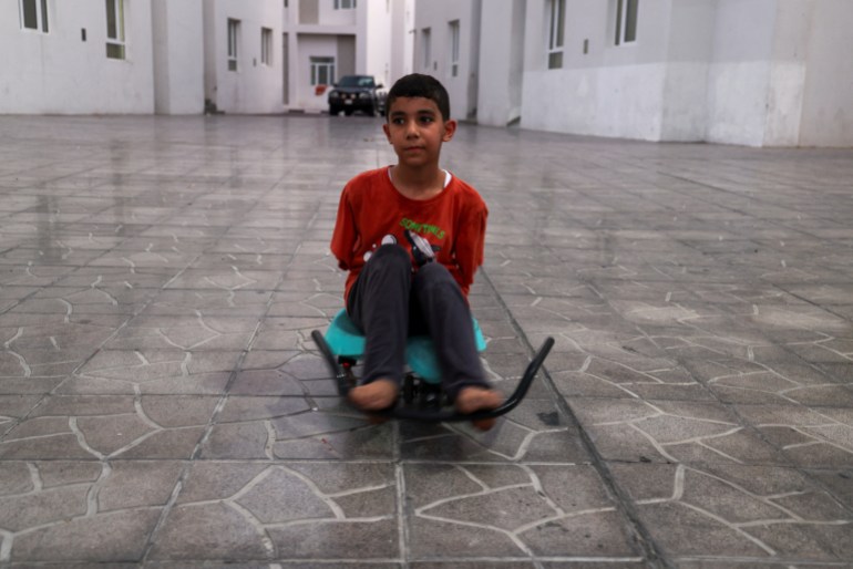 mahmoud ajjour, an injured child evacuated from gaza, plays in a yard in front of his house in doha, qatar, september 10, 2024. reuters/ibraheem abu mustafa