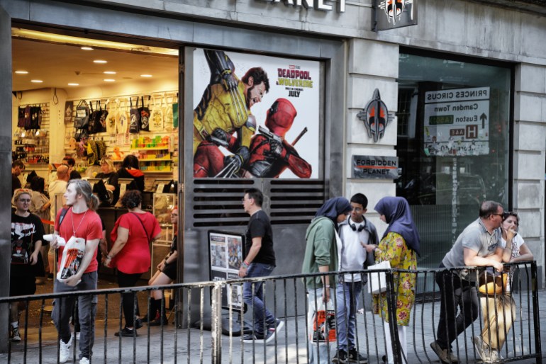 London, England, United Kingdom - Date: August 11, 2024 - Store Window Display, Deadpool & Wolverine (also known as Deadpool 3 - Ryan Reynolds as Deadpool, Hugh Jackman as Wolverine) movie poster, Marvel Cinematic Universe (MCU), displayed at Shaftesbury Avenue Street located in Central London, specifically within the City of Westminster. Central Core of London, an integral part of Central London's transport and commercial landscape; Downtown London (Inner London).