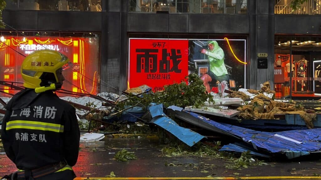 Typhoon floods roads with water and broken tree branches in Shanghai