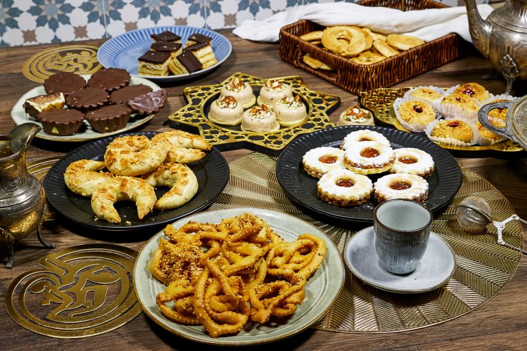 happy eid al fitr concept, group of different tradition coookies of algeria on wood table for ramadan or eid ; shutterstock id 2450275955; purchase_order: ajanet; job: ; client: ; other: