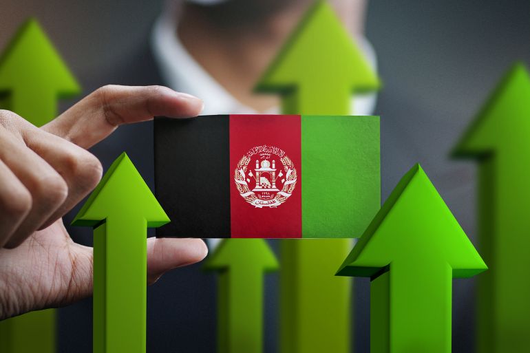 nation growth concept, green up arrows - businessman holding card of afghanistan flag