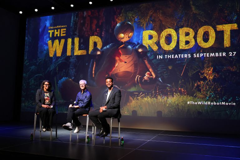 LOS ANGELES, CALIFORNIA - SEPTEMBER 25: (L-R) Jacqueline Coley, Chris Sanders, and Kris Bowers speak onstage during The Wild Robot Los Angeles screening and tastemaker event presented by DreamWorks Animation at Ross House on September 25, 2024 in Los Angeles, California. Leon Bennett/Getty Images for DreamWorks Animation/AFP (Photo by Leon Bennett / GETTY IMAGES NORTH AMERICA / Getty Images via AFP)