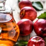 Apple cider vinegar or bottle of alcohol drink from fresh apples, organic food, healthy diet concept