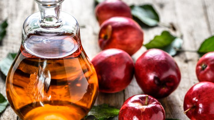 Apple cider vinegar or bottle of alcohol drink from fresh apples, organic food, healthy diet concept