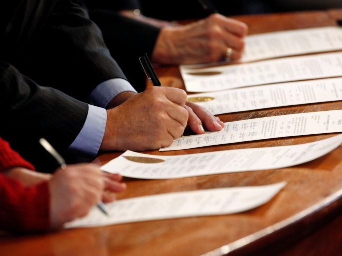 north carolina electoral college representatives sign the certificates of vote after they all cast their ballots for u.s. president-elect donald trump in the state capitol building in raleigh, north carolina, u.s., december 19, 2016. reuters/jonathan drake