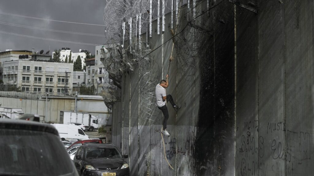 Palestinians in West Bank risk crossing Israel’s separation barrier to flee failing economy