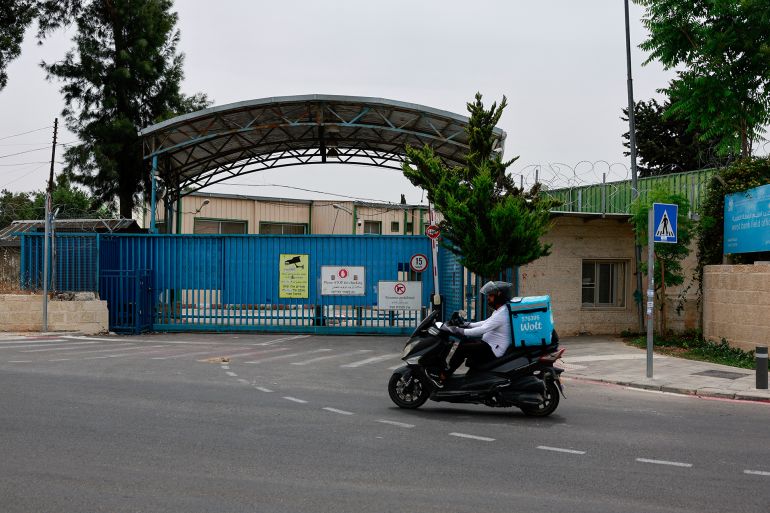 a man drives a scooter past the unrwa headquarters, in jerusalem, may 10, 2024. reuters/ammar awad