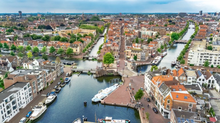 aerial drone view of leiden town cityscape from above, typical dutch city skyline with canals and houses, holland, netherlands