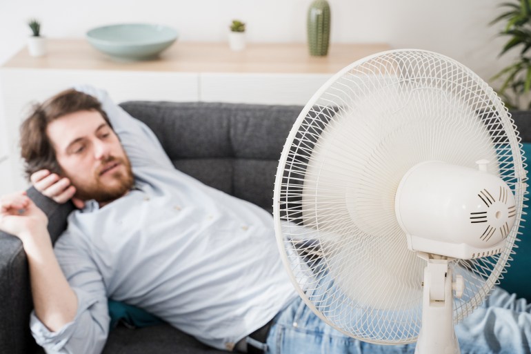 One guy portrait suffering from summer heat at home; Shutterstock ID 1741464473; purchase_order: AJ; job: ; client: ; other: