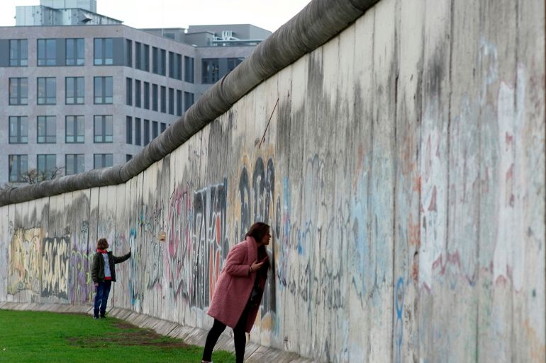 people touch remains of the berlin wall at the wall memorial on bernauer strasse in berlin, germany, november 8, 2019. on november 9th germany will mark the 30th anniversary of the fall of the berlin wall (berliner mauer) in 1989. reuters/fabrizio bensch