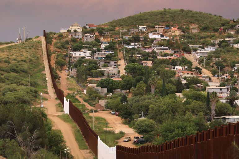 nogales, az - july 22: the u.s.-mexico border fence is seen at sunset on july 22, 2018 in nogales, arizona. on right is nogales, mexico. security cameras are seen mounted on towers over both sides of the border. president trump has proposed replacing the fence with a wall.   john moore/getty images/afp== for newspapers, internet, telcos & television use only ==