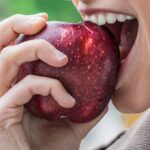 girl eats an apple