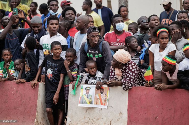 mali-guinea-politics-diplomacy-goita-doumbouya supporters hold a poster depicting malis interim leader and head of junta, colonel assimi goïta (l) and guinea interim leader and head of junta, mamady doumbouya (r), in bamako, mali, on september 22, 2022 during mali's independence day military parade. (photo by ousmane makaveli / afp) (photo by ousmane makaveli/afp via getty images)