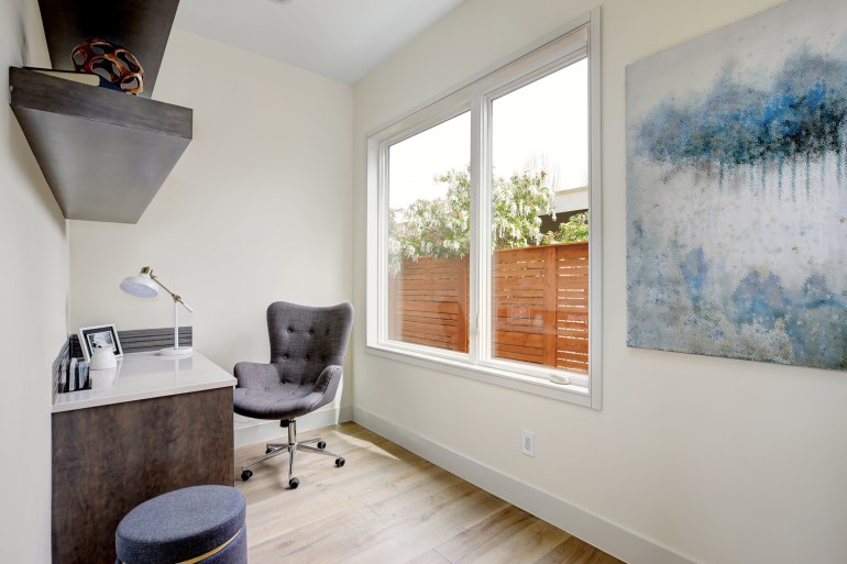 light small home office interior with corner desk and grey upholstered chair on hardwood floor. northwest, usa; shutterstock id 644816251; purchase_order: aj; job: ; client: ; other: