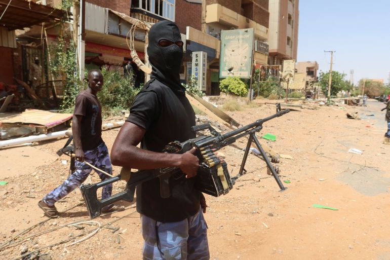 a member of sudanese armed forces looks on as he holds his weapon in the street in omdurman, sudan, march 9, 2024. reuters/el tayeb siddig