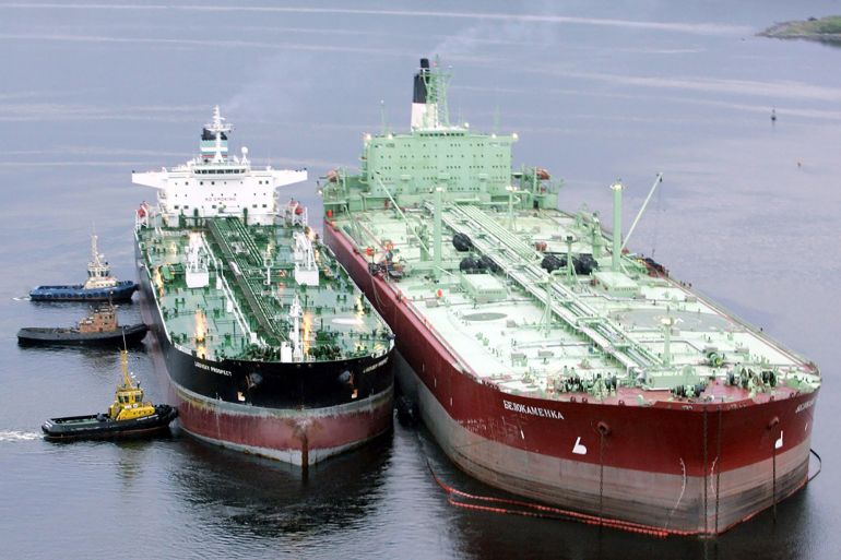 In this file photo, an oil tanker (R) is being pushed towards a storage tanker at the Belokamenka Oil Terminal in Kolsky Bay near the northwestern Russian port city of Murmansk June 19, 2006. Belokamenka is a Rosneft offshore facility on the Barents Sea. (Sergei Karpukhin/Reuters)