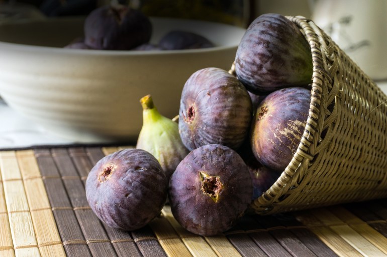 Close up of fig fruits in a cane basket.