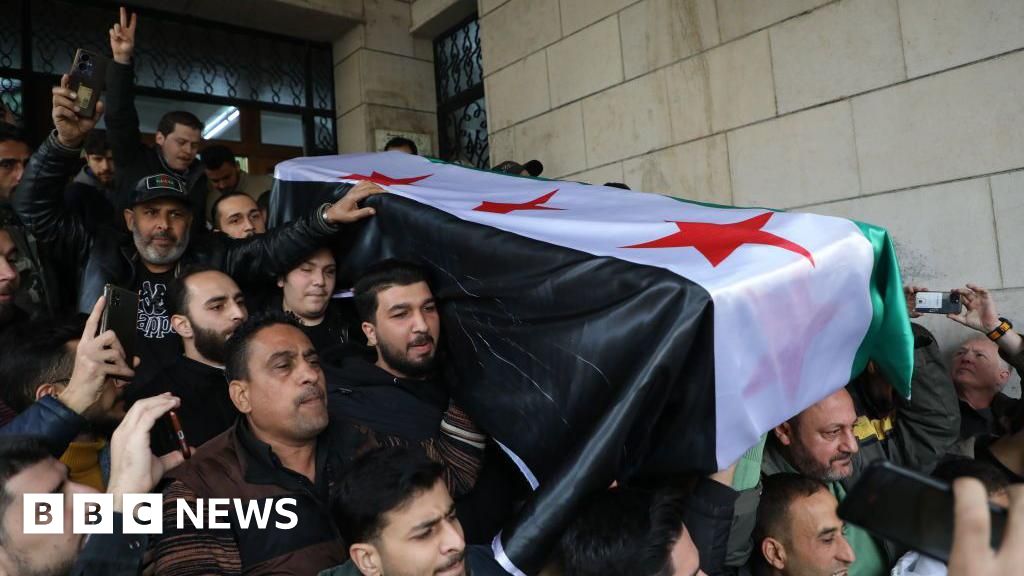 'I wish he'd lived to see new Syria' - Crowds bury anti-Assad activist