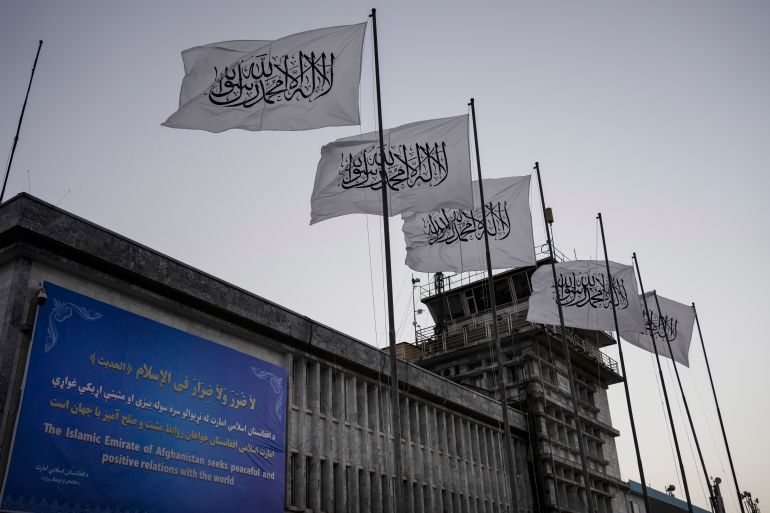 FILE - Taliban flags fly at the airport in Kabul, Afghanistan, Sept. 9, 2021. Two years on from the Taliban takeover of Afghanistan, the United States has begun easing rules that could allow commercial airlines to fly over the country in routes that cuts time and burned fuel for East-West travel. But those flights shortening routes for India and Southeast Asia raise questions never answered during the Taliban's previous rule from the 1990s to the months after the Sept. 11, 2001, attacks. (AP Photo/Bernat Armangue, File)