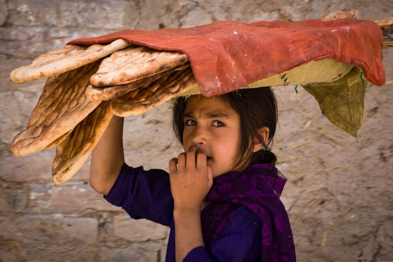 Kabul Afghanistan, May 2004: Collecting bread in Kabul; Shutterstock ID 1142603966; purchase_order: aj; job: ; client: ; other: