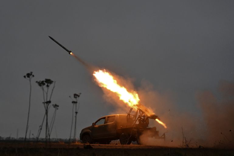 Members of the artillery unit of the special rifle battalion of Zaporizhzhia region police fire a small multiple launch rocket system (MLRS) towards Russian troops in a front line, amid Russia's attack on Ukraine, in Zaporizhzhia region, Ukraine December 25, 2024. REUTERS/Stringer