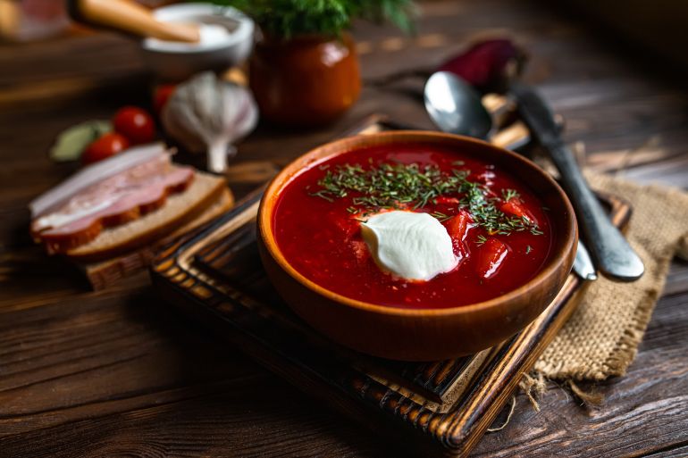 Traditional Ukrainian Russian borscht . Bowl of red beet root soup borsch with white cream . Beet Root delicious soup . Traditional Ukraine food cuisine.