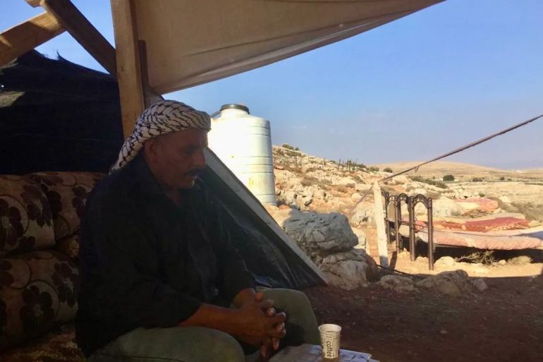 Abu Bashar has been forced to sleep out in the open with his family after Israeli settler attacks forced them out of their home in the village of Wadi as-Seeq [Faris Ka'abneh/Al Jazeera]