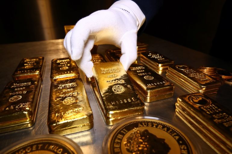 Gold bars and coins are stacked in the safe deposit boxes room of the Pro Aurum gold house in Munich, Germany,  August 14, 2019. REUTERS/Michael Dalder