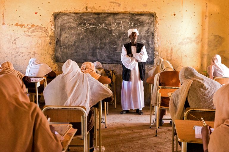 A teacher invigilates middle school students during their end-of-year exams in the northern Sudanese village of Usli on November 24, 2024. (Photo by AFP)